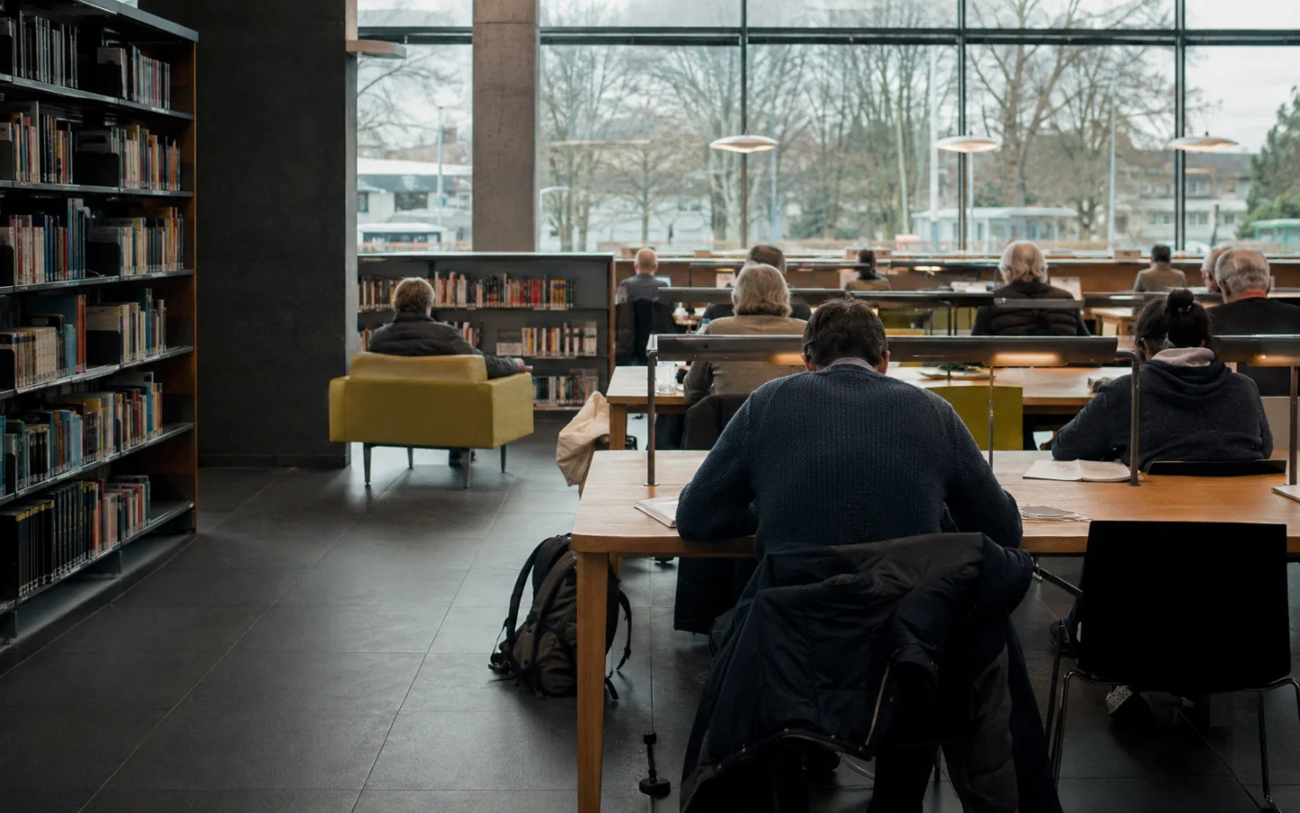Readers sharing long tables in a neighborhood library